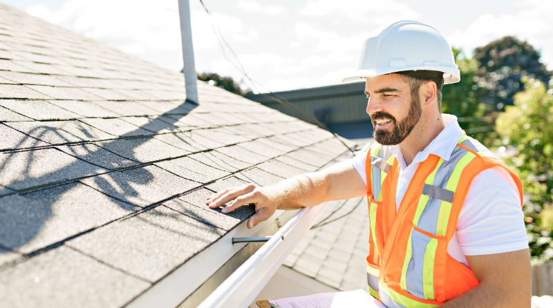 roofer standing on ladder